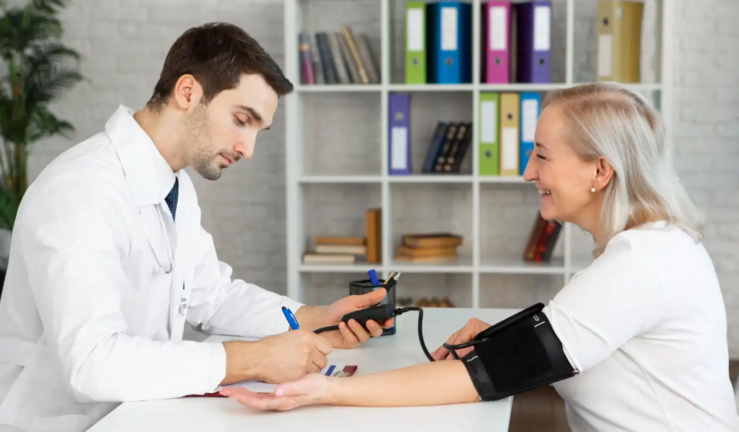 Healthcare professional reviewing preventive health screening results with a patient during a routine medical checkup.