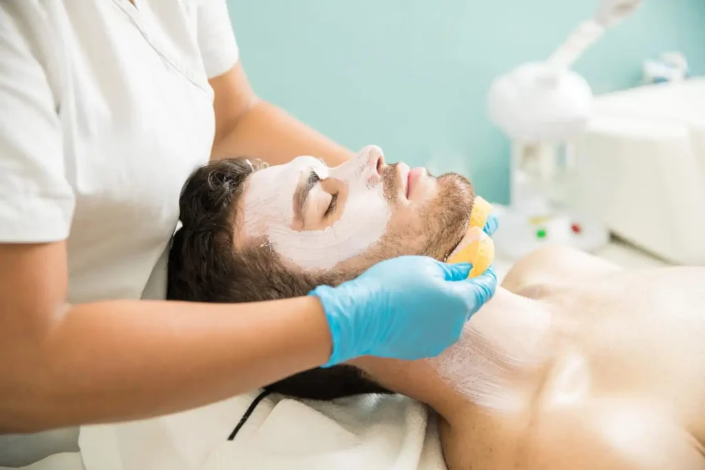 Man following a daily skincare routine by cleansing, moisturizing, and applying sunscreen to maintain healthy skin.