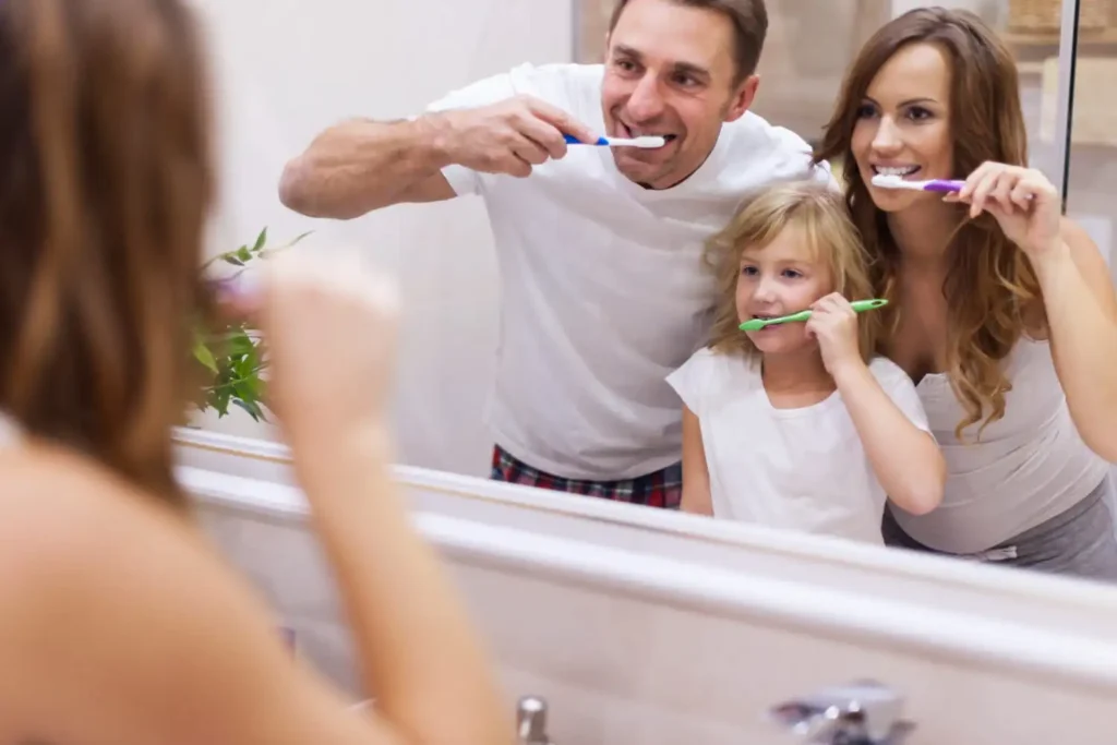 Person brushing teeth, flossing, and using mouthwash as part of a complete daily oral hygiene routine.