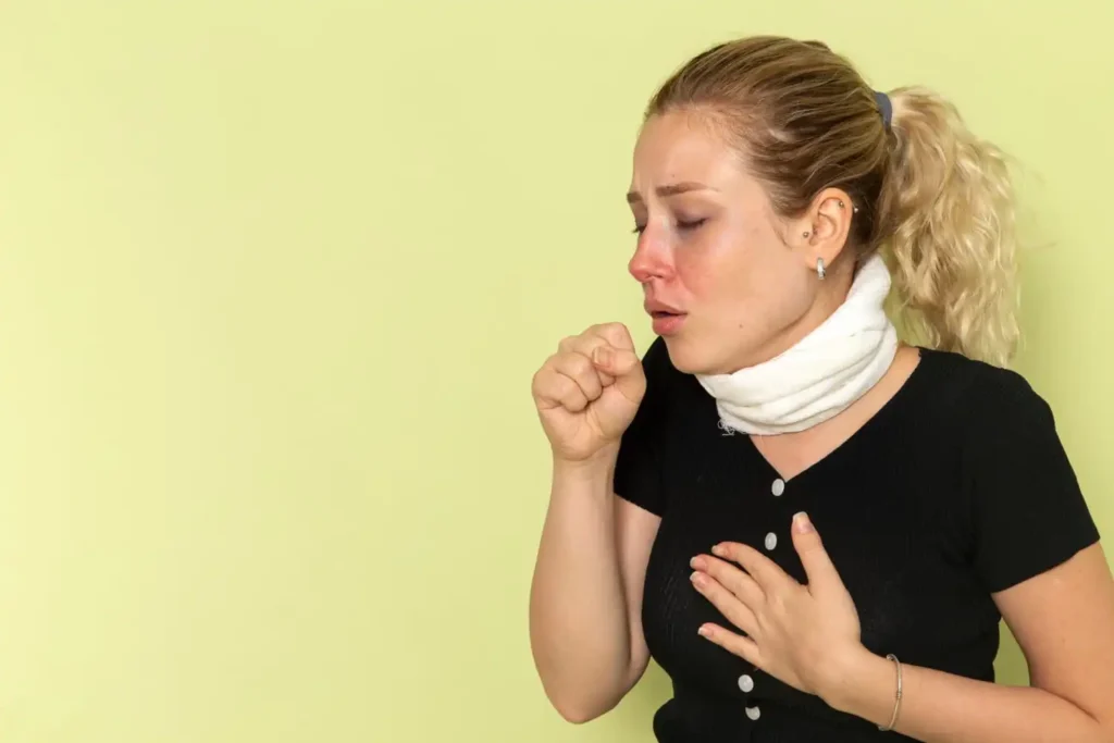 Person experiencing dry mouth while reviewing heart health warning signs and symptoms with a healthcare information chart.