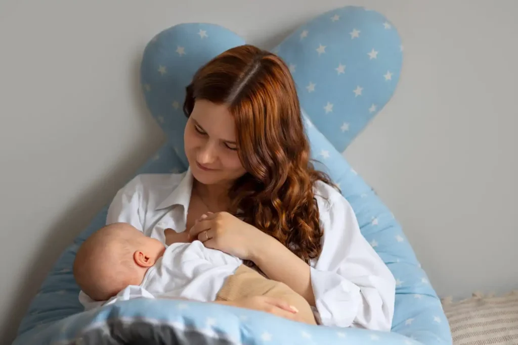 Parent exclusively breastfeeding a newborn in a comfortable home setting, highlighting infant nutrition, bonding, and the importance of breast milk during the first six months.